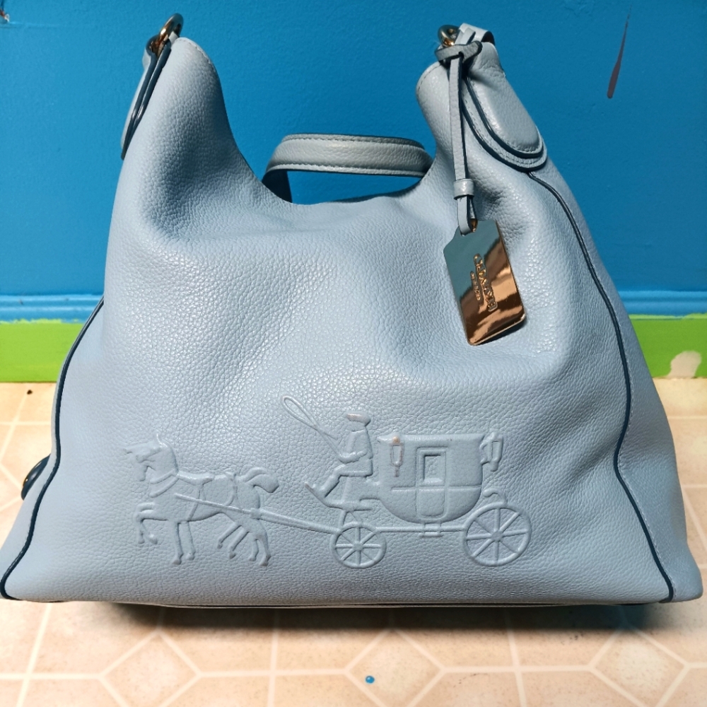 Vintage brand new Coach bag. Includes one bottle of Coach leather cleaner.